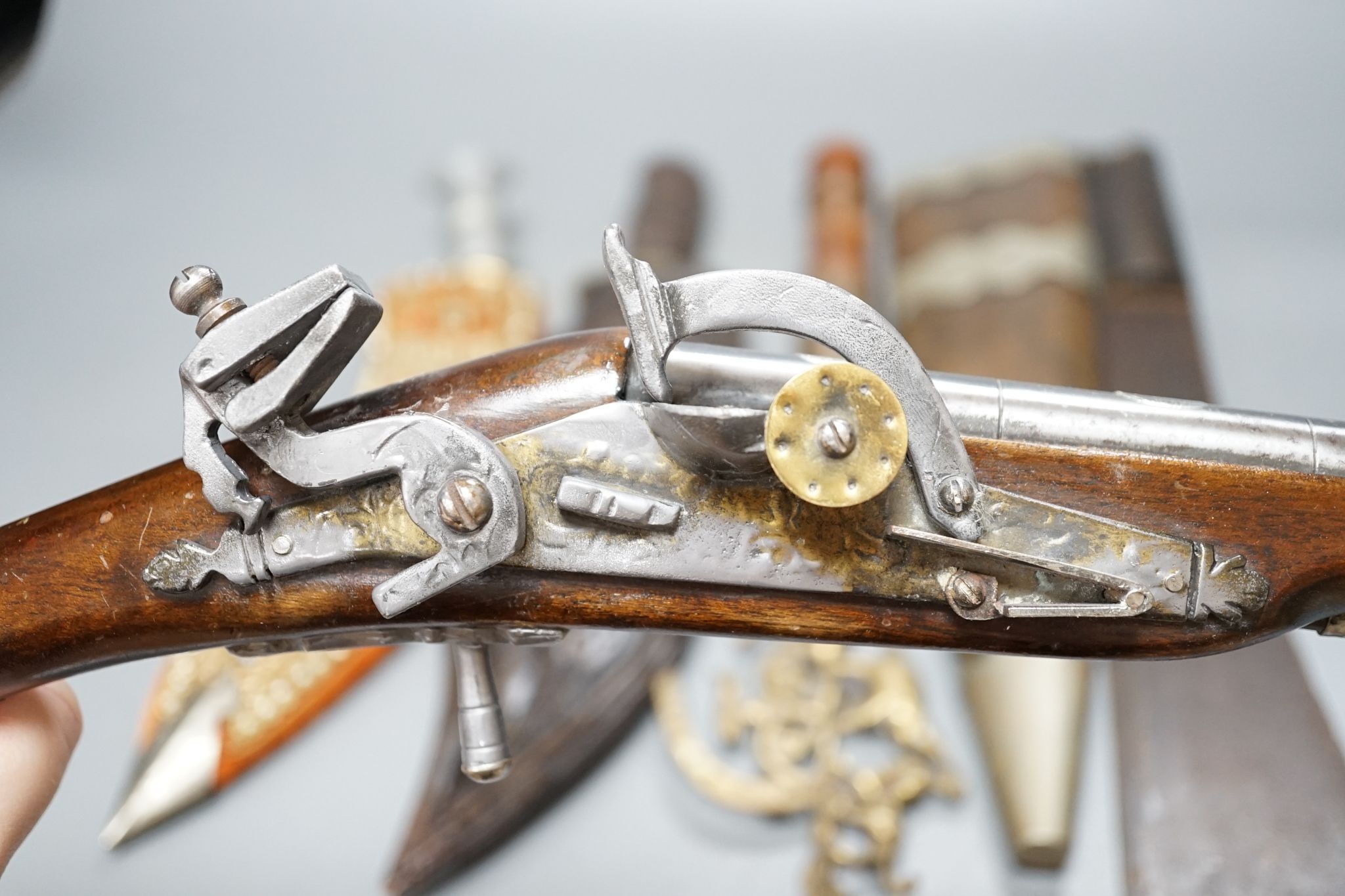 A replica flintlock pistol, machete, etc.